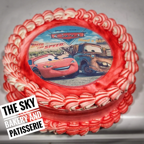 C116 - Large Round Colourful Cake with Red Cars